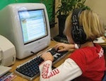 Student on a computer, using headphones